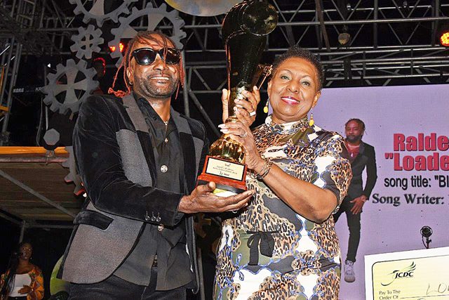 Photo 1 - Raldene 'Loaded Eagle' Dyer receives winning trophy from Min O...